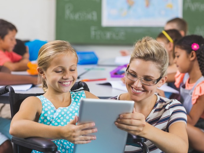 Ein Mädchen wird durch ihre Schulbegleiterin in der Schule unterstützt. Quelle: © WavebreakMediaMicro /stock.adobe.com