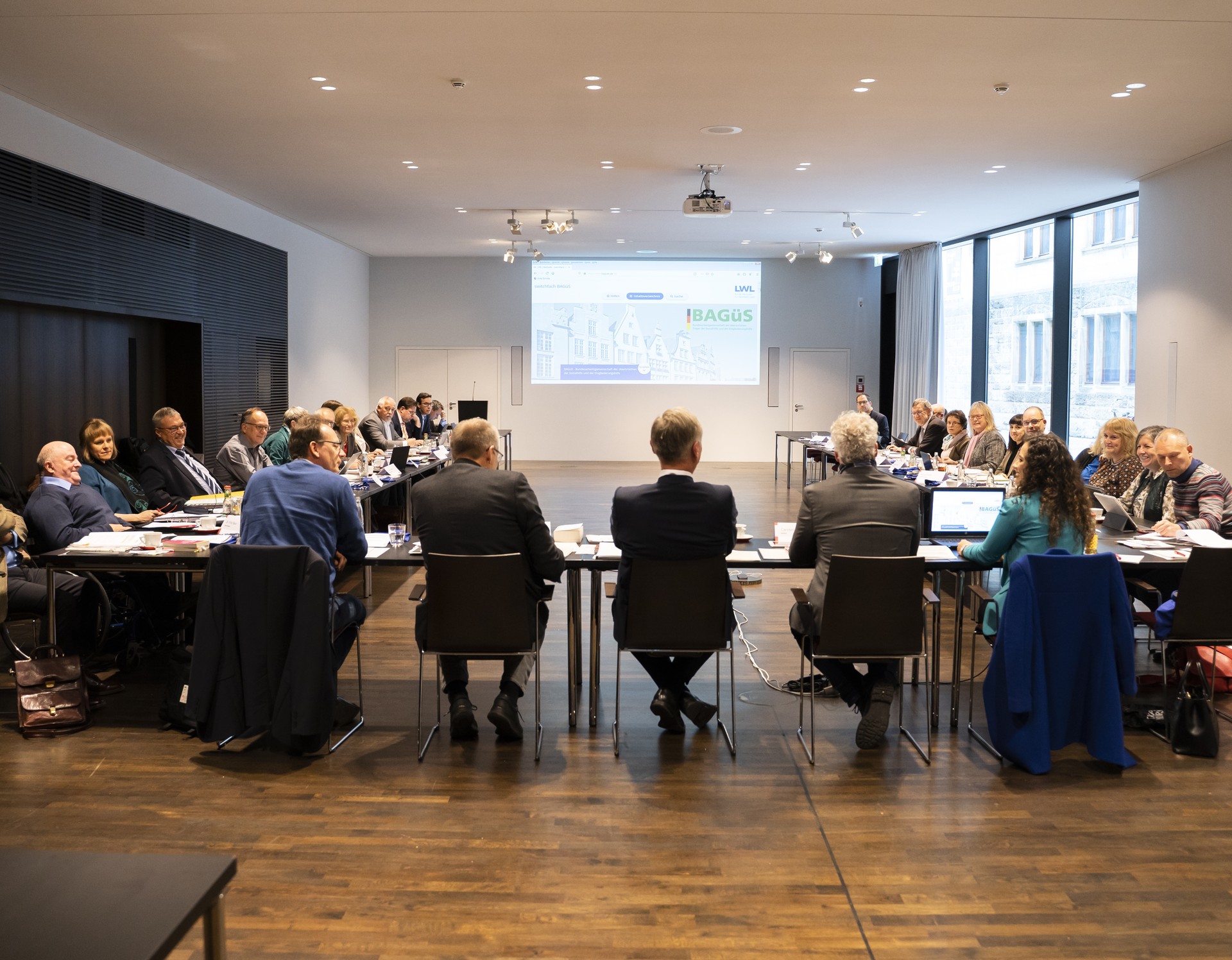 Unsere Mitglieder sitzen im Sitzungssaal während der Mitgliederversammlung in Münster. Quelle: © BAGüS
